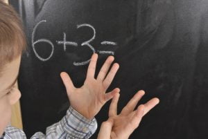 Diagnose ADHD LD When Things Dont Add Up Dyscalculia Article 10703 Boy adding at Blackboard 3